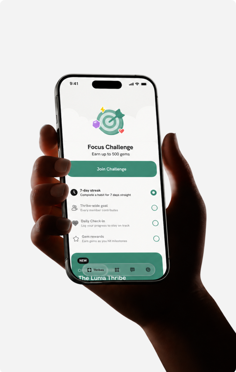 A hand holding a phone showing a Focus Challenge interface